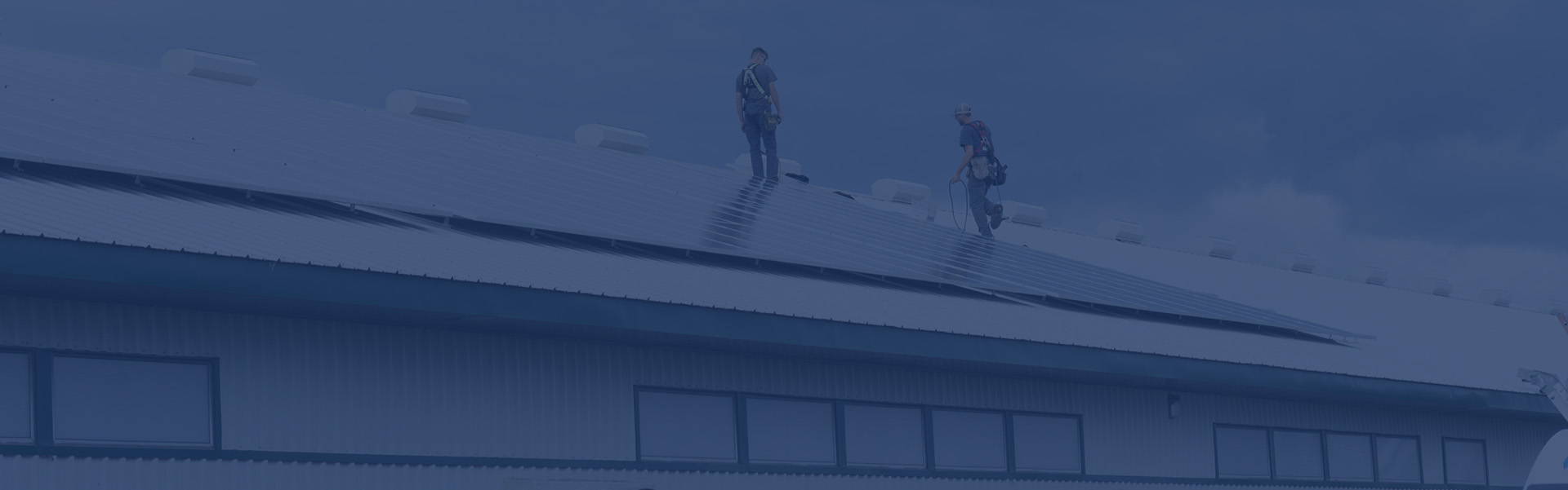 workers on roof doing maintenance on solar panel